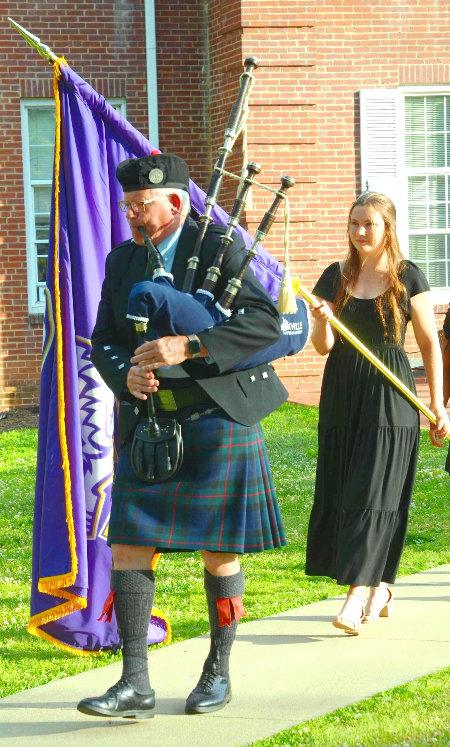Bagpiper Tracy Wilson leads the Commencement processional