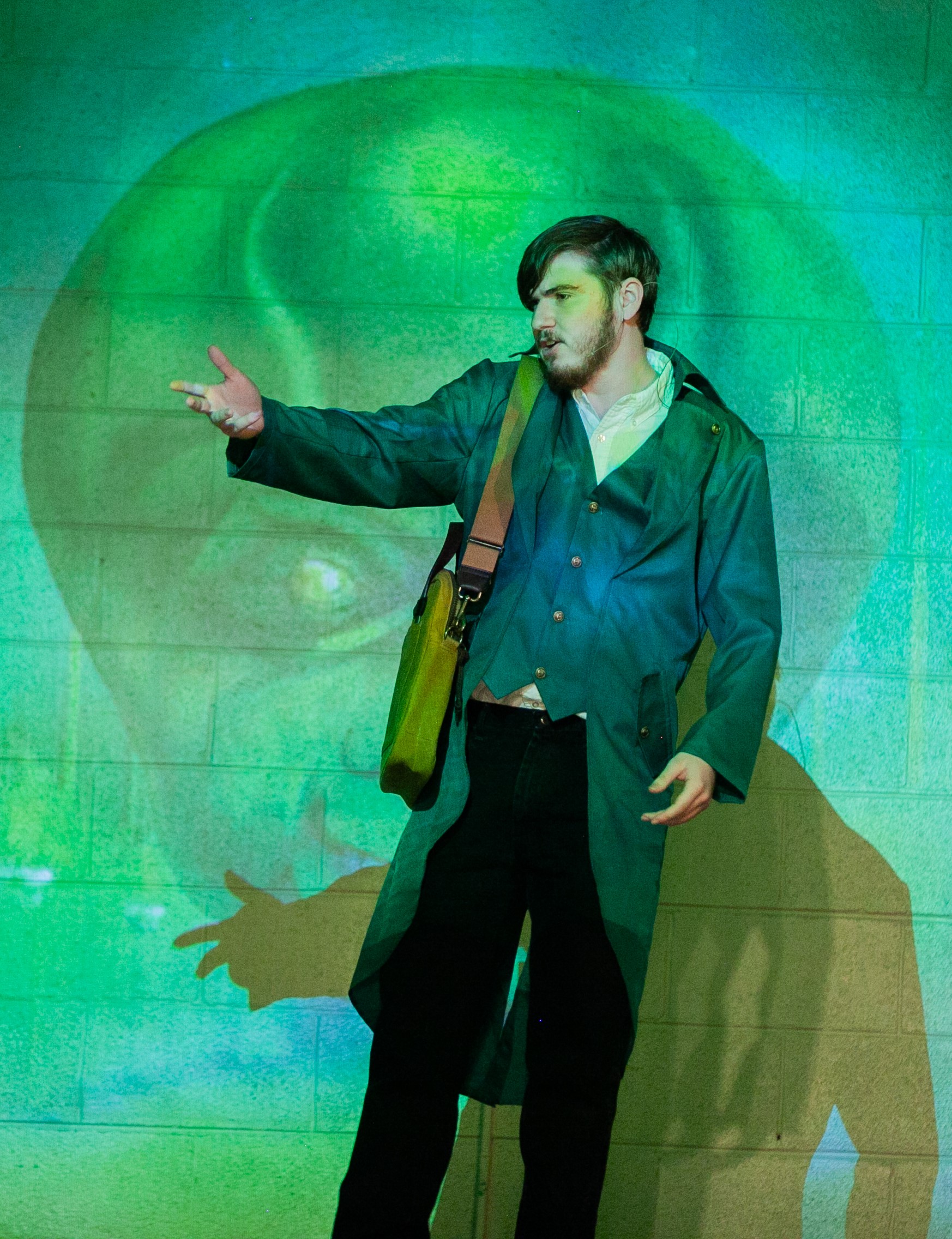 Student actor performing under green stage lighting in The Wizard of Oz