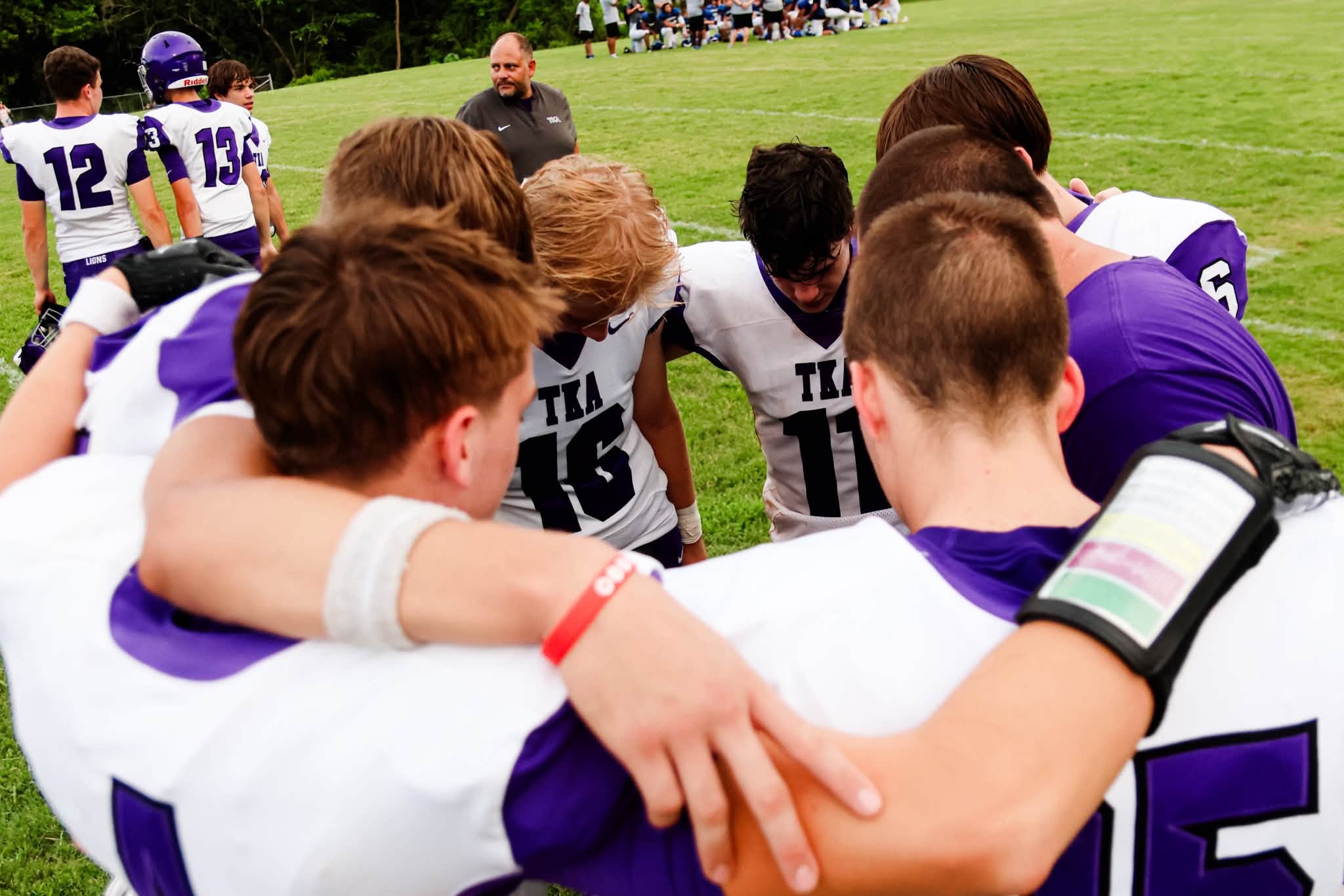 The King’s Academy football team gathered in a huddle