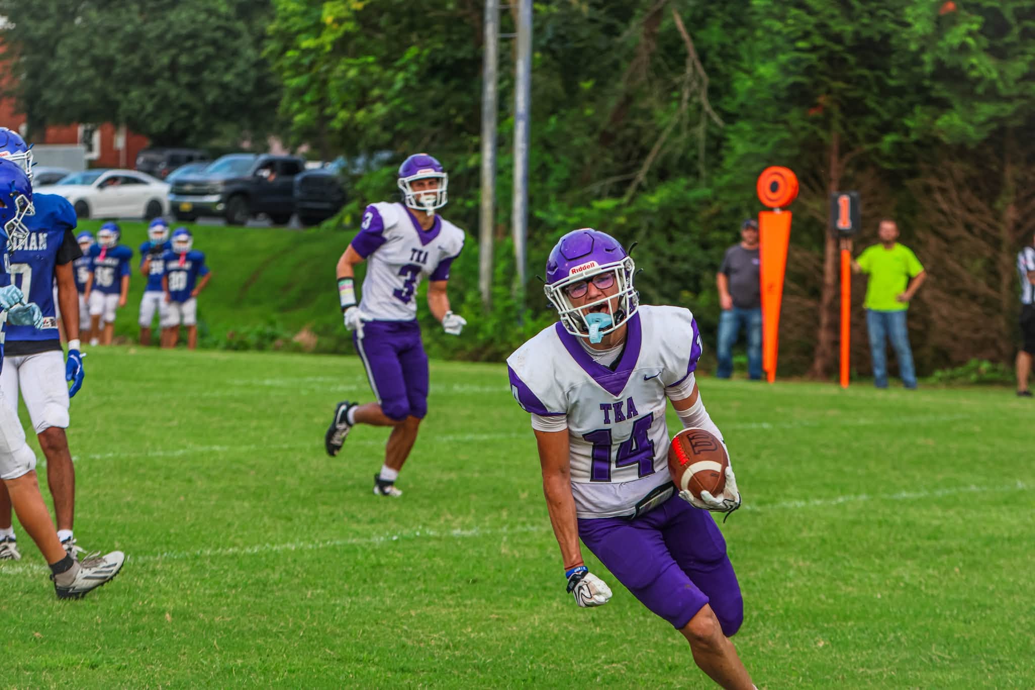 The King’s Academy football player running with the ball during game action