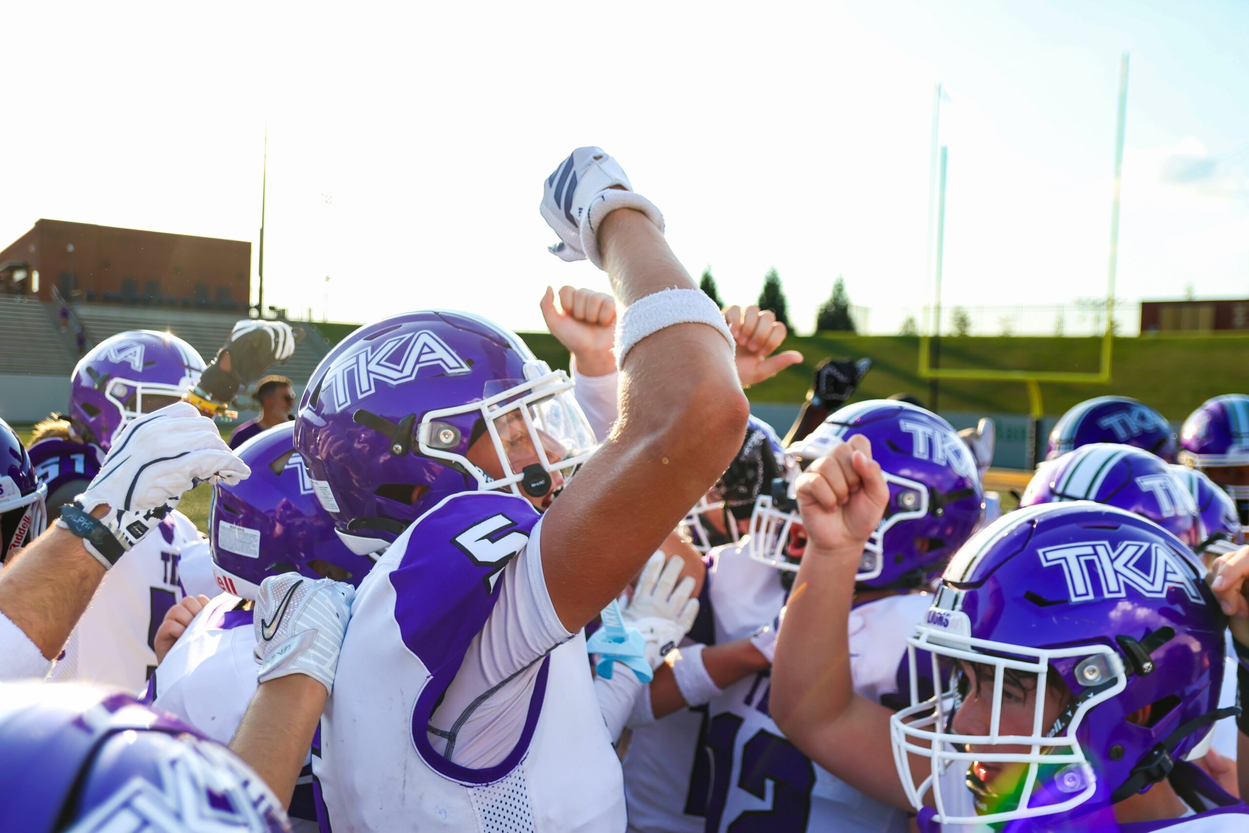 The King’s Academy football team celebrating together before game action