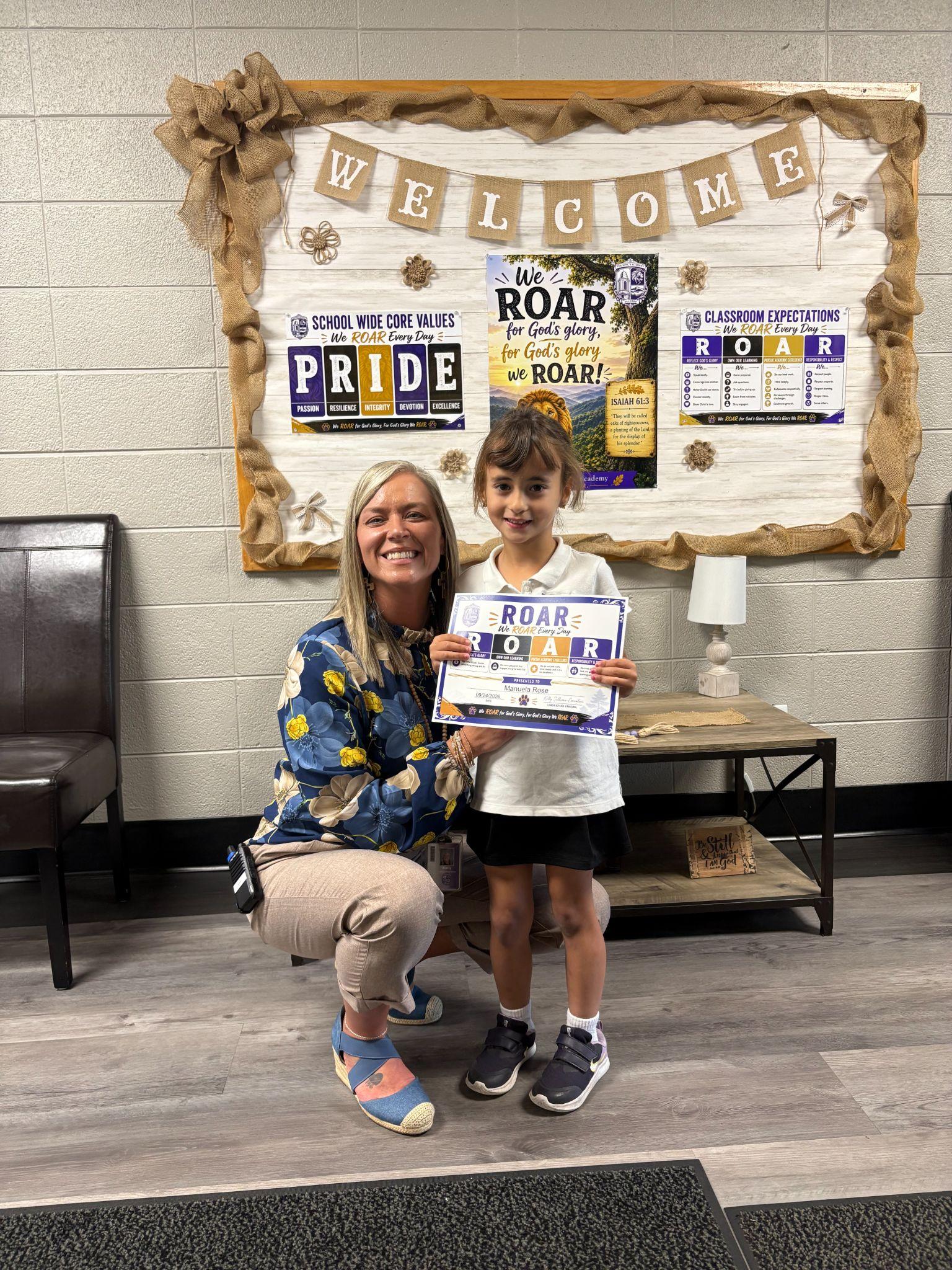 Manuela Rose with her ROAR Student of the Week certificate